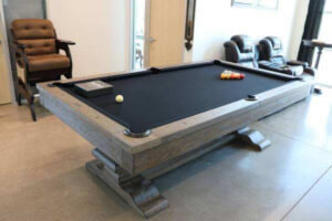 Light wood custom pool table with black felt.
