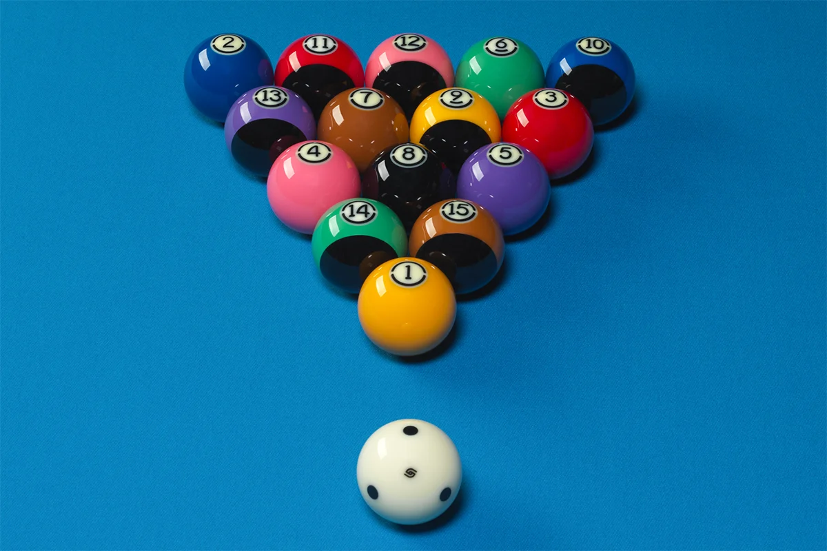 A set of pool balls on a blue felt background.