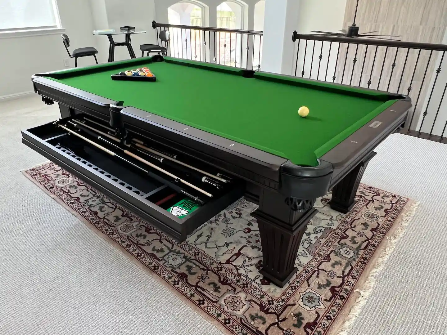 Pool table with bright green felt installed by Trooper Billiards inside of an Austin home.