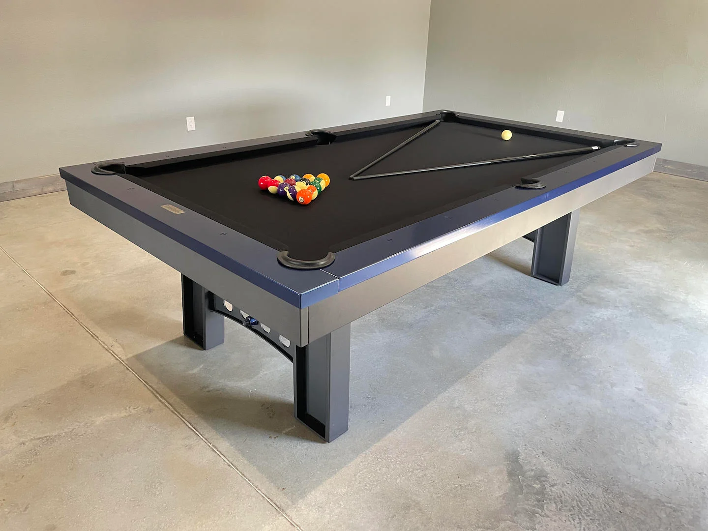 Pool table with black felt, installed by a professional pool table moving company.